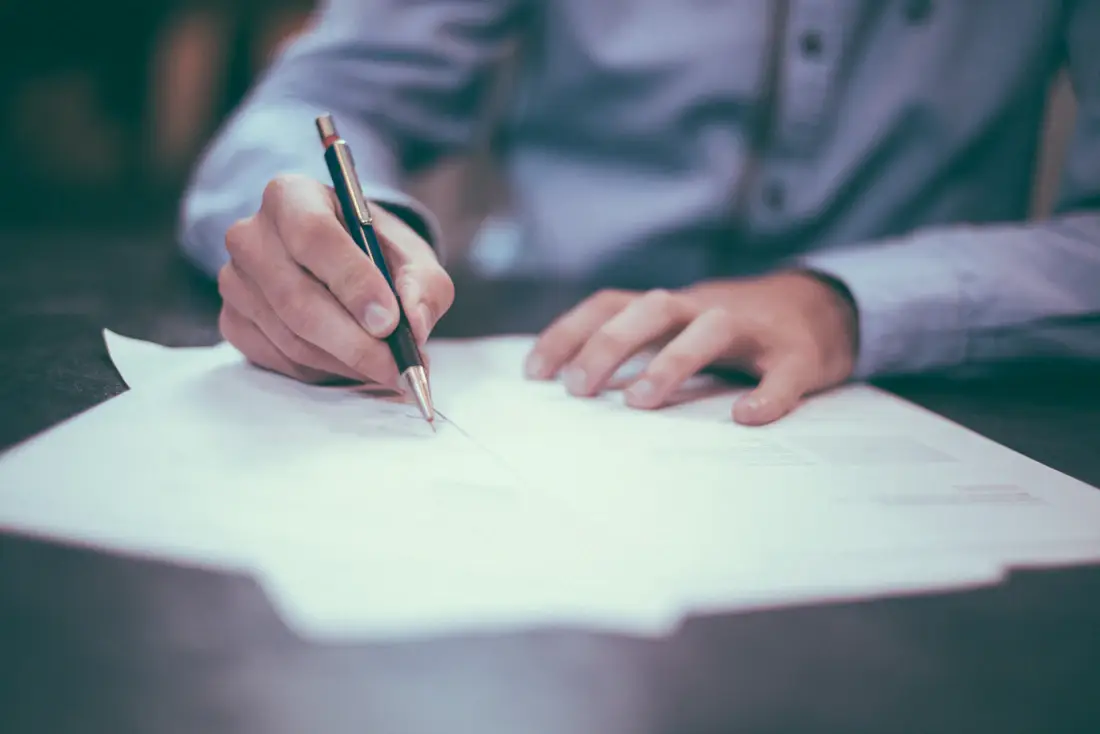 Business professional reviewing documents and approval records